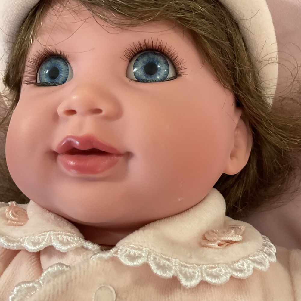 Adorable Baby Doll with Blue Eyes and Pink Outfit